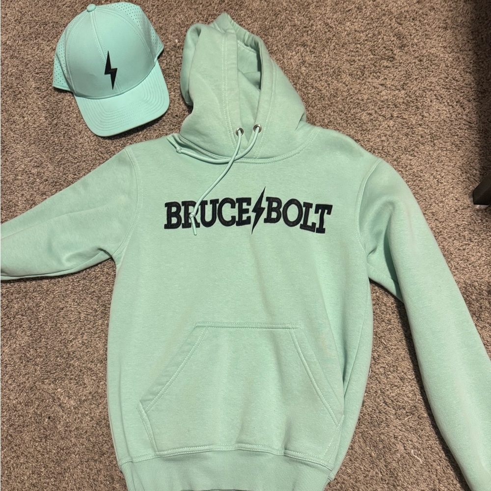 Bruce bolt youth large sweatshirt and matching hat. Neither has ever been worn.